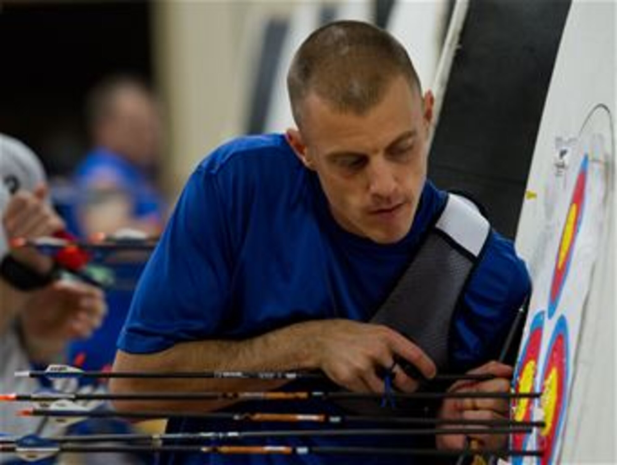 Tech. Sgt. Benjamin Koren, 607th Air control Squadron ground radar systems NCO-in-charge and an Air Force Wounded Warrior athlete, removes his arrows from a target at an archery practice session during the first day of the Department of Defense Warrior Games training camp at Eglin Air Force Base, Florida. The five-day training camp served as their last practice session before the Warrior Games June 19 through 28. 
