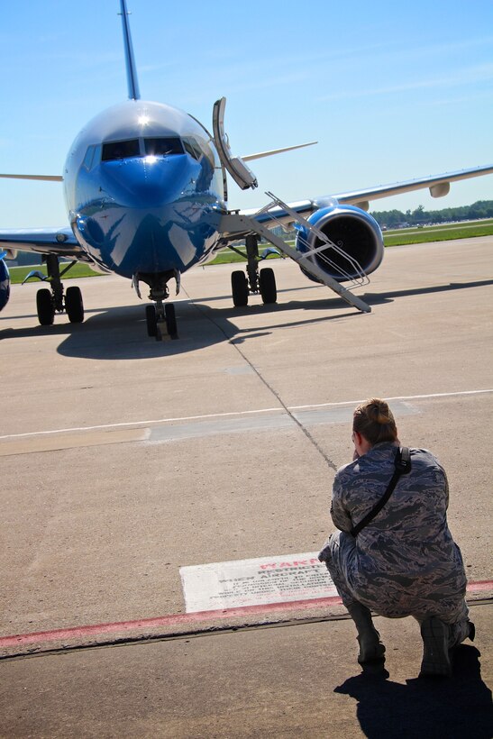 Tech. Sgt. Jodi Ames, newest member of the 932nd Airlift Wing Public Affairs office, kneels to get a great angle of a parked C-40 aircraft, Scott Air Force Base Ill., July 14, 2015. The 932nd AW is an Air Force Reserve that flies the C-40, an operational support and team travel aircraft. 