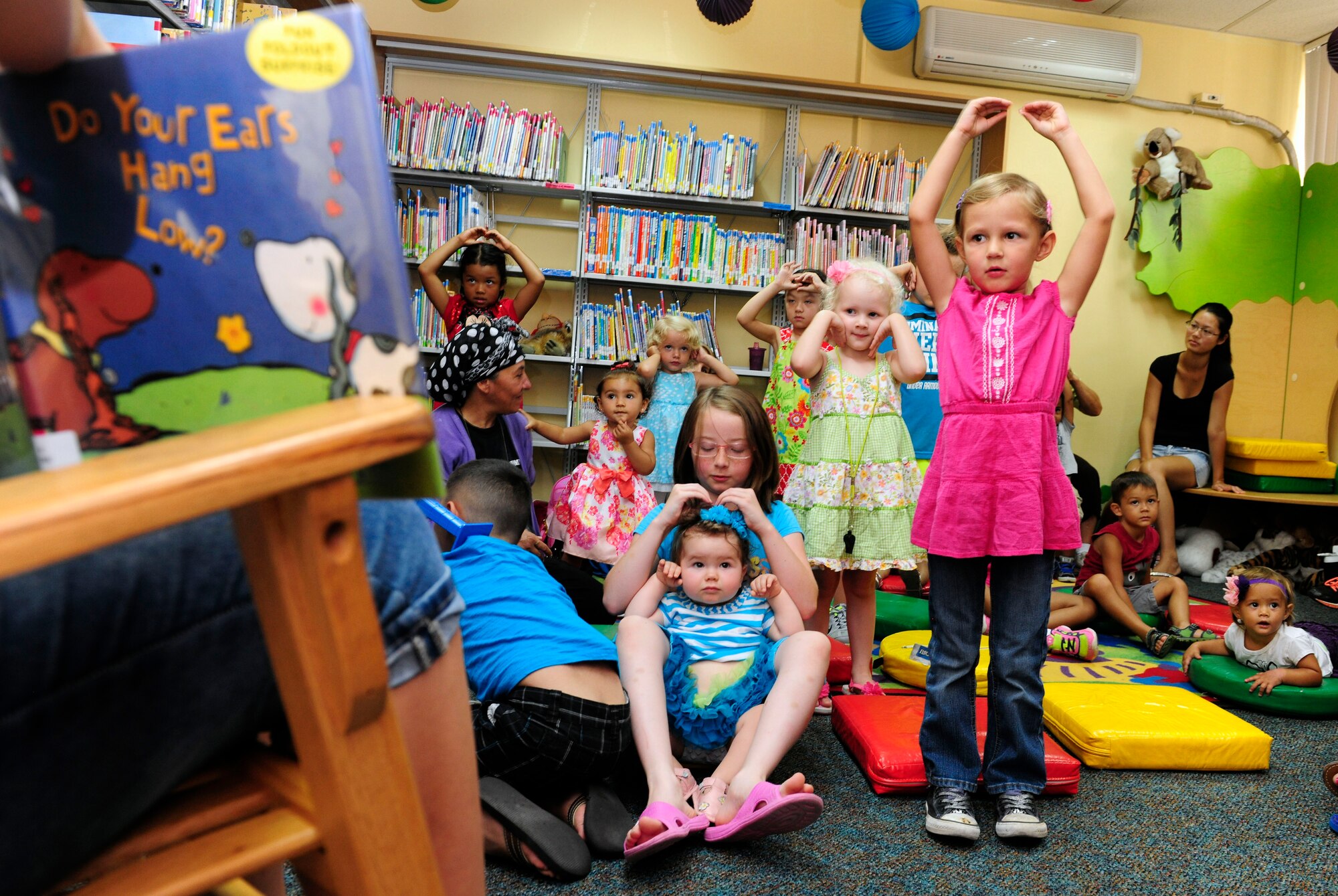 Children act out motions during a storytelling event at the base library during a kick-off event for the Department of Defense Summer Reading Program July 14, 2015, Incirlik Air Base, Turkey. The library will be offering weekly events to children one to 12-years old during the six-week program. (U.S. Air Force photo by Senior Airman Krystal Ardrey/Released)