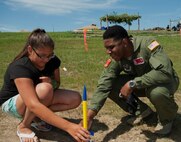 2nd Lt. Cornelius Hall, 740 Missile Squadron missile combat crew deputy, helps set up a model rocket with a local New Town student during a Minot outreach event, New Town, N.D., July 16, 2015. Members of Minot Air Force Base volunteered at this event to help educate and inspire local students on Air Force opportunities and the mission of the 91st Missile Wing. (U.S. Air Force photo/Airman 1st Class Christian Sullivan)