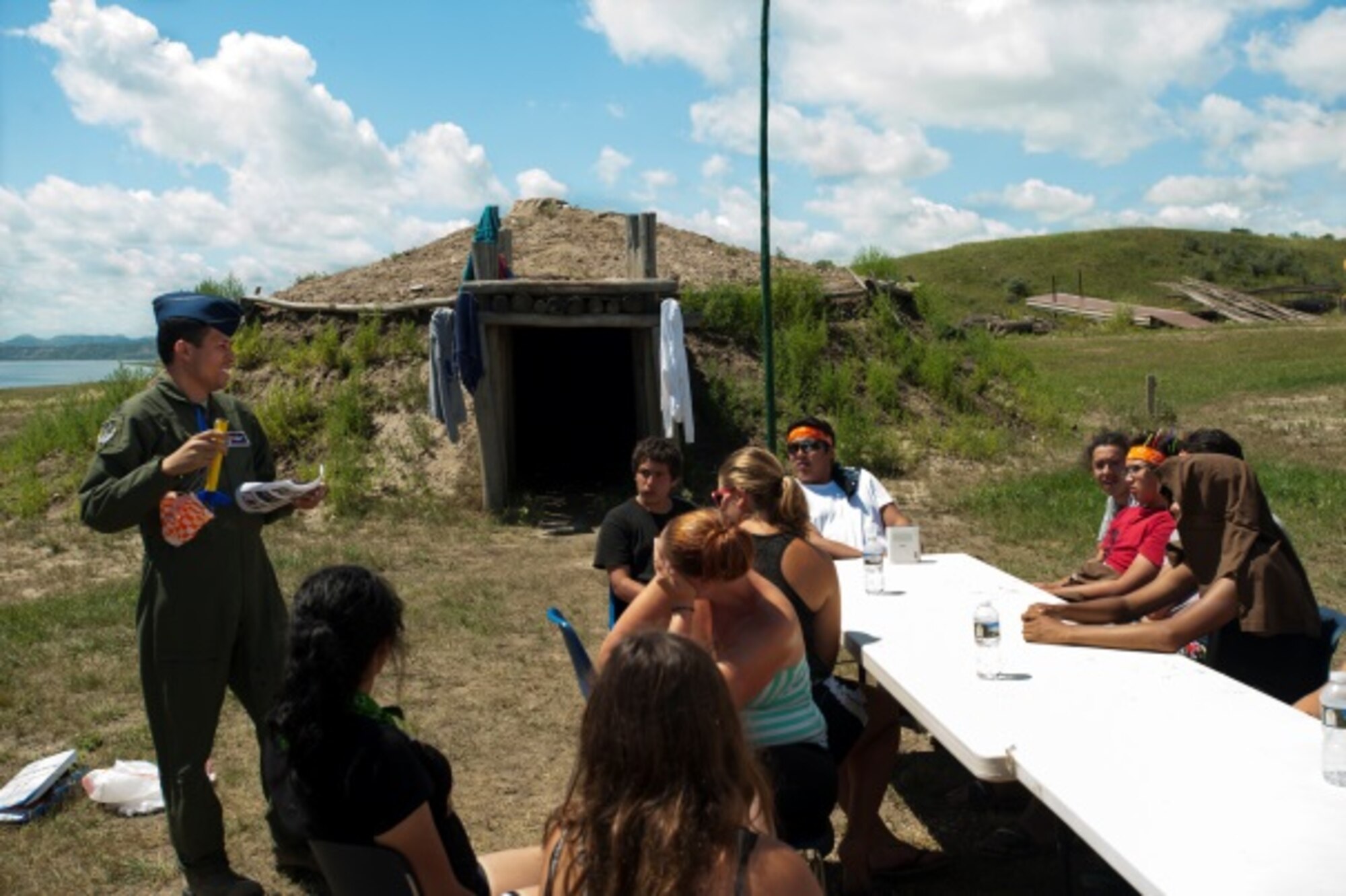 Lt. Col Mike Samuel, 91st Missile Wing Inspector General, demonstrates with a model rocket at a Minot outreach event, New Town, N.D., July 16, 2015. Minot members traveled to New Town to educate and inspire local students on Air Force opportunities and the mission of the 91st Missile Wing. (U.S. Air Force photo/Airman 1st Class Christian Sullivan)