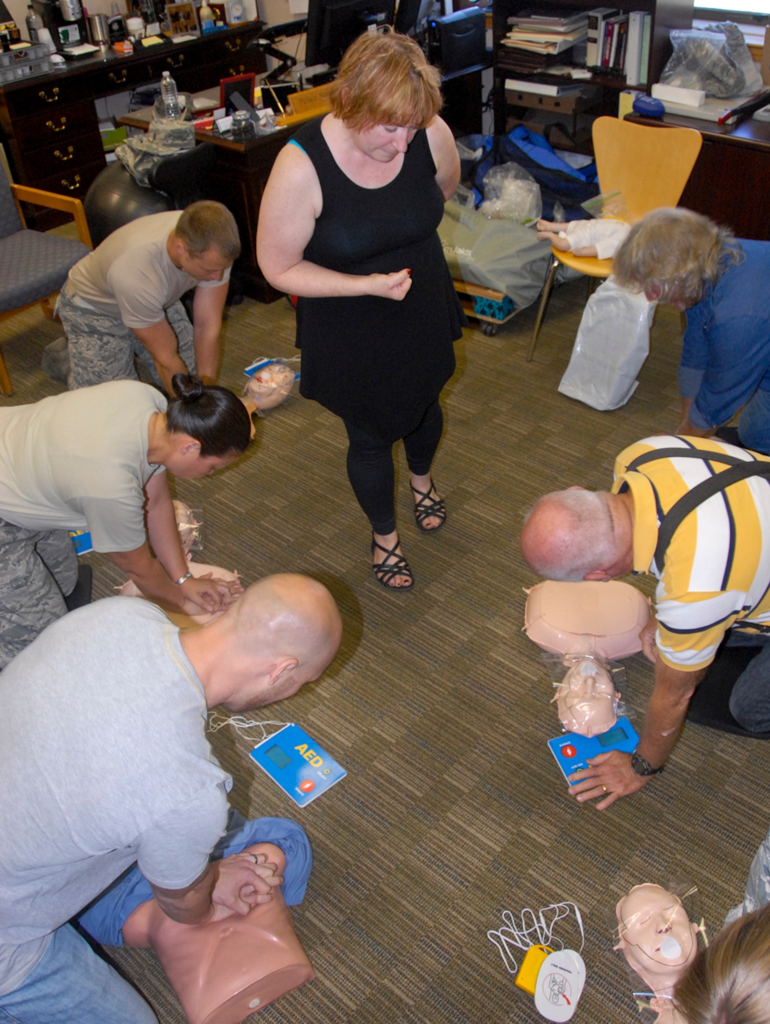 Peggy Shepherd, a cardiopulmonary resuscitation and automated external defibrillator instructor, teaches students proper operating procedures during a CPR/AED training class June 19 at Eglin Air Force Base, Fla.  Shepherd normally offers on-base CPR classes quarterly. (U.S. Air Force photo/Kevin Gaddie)