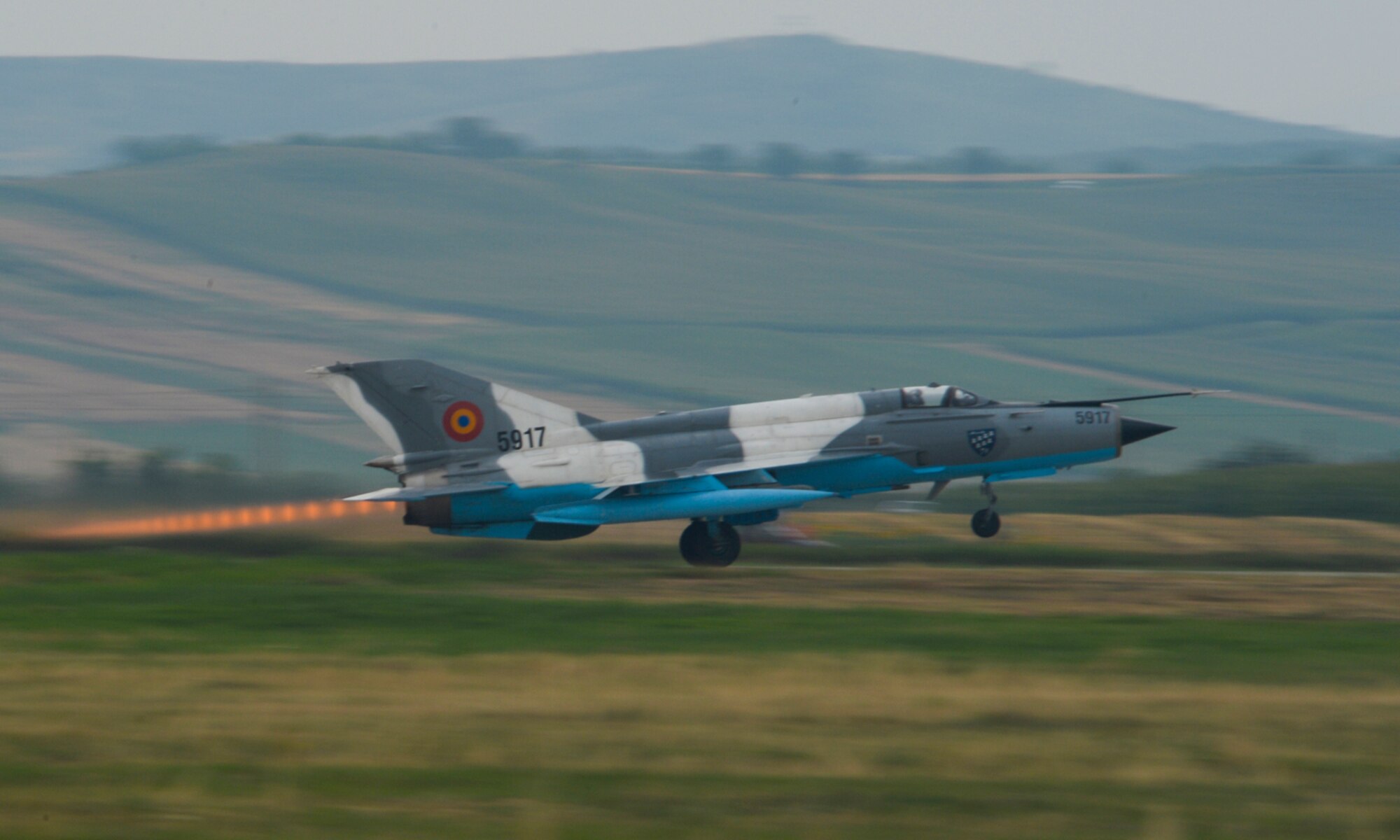 A Romanian MiG-21 fighter aircraft takes off during the 2015 Campia Turzii Air Show July 19, 2015, at Campia Turzii, Romania. The air show celebrated the Romanian air force’s birthday and had static displays of aircraft, tanks and military equipment. (U.S. Air Force photo by Senior Airman Dylan Nuckolls/Released)