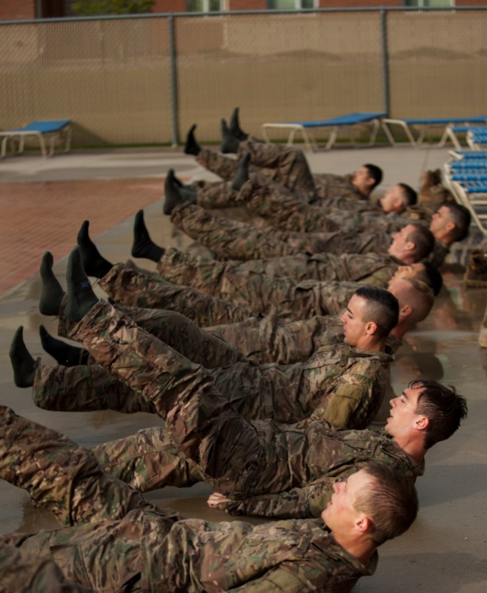 Airmen perform calisthenics before performing a combat water survival assessment during a ranger assessment course at Minot Air Force Base, N.D., July 15, 2015. To pass the course Airmen are required to complete a Ranger Physical Assessment, combat water survival assessment, 12 –mile foot march and day and night combined land navigation. (U.S. Air Force photo/Airman 1st class Christian Sullivan)