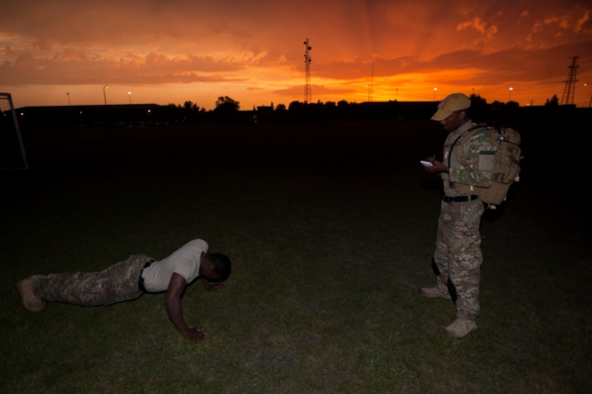 Airman 1st Class Anthony Styles, 5th Security Forces Squadron ranger assessment course trainee, races the clock to finish the push up portion of the Ranger Physical Assessment at Minot Air Force Base, N.D., July 15, 2015. To qualify to be a ranger, Styles is required to complete a minimum of 49 push ups, 59 sit ups, and a six chin ups along with a five-mile run in 40 minutes or less. (U.S. Air Force photo/Airman 1st Class Christian Sullivan)