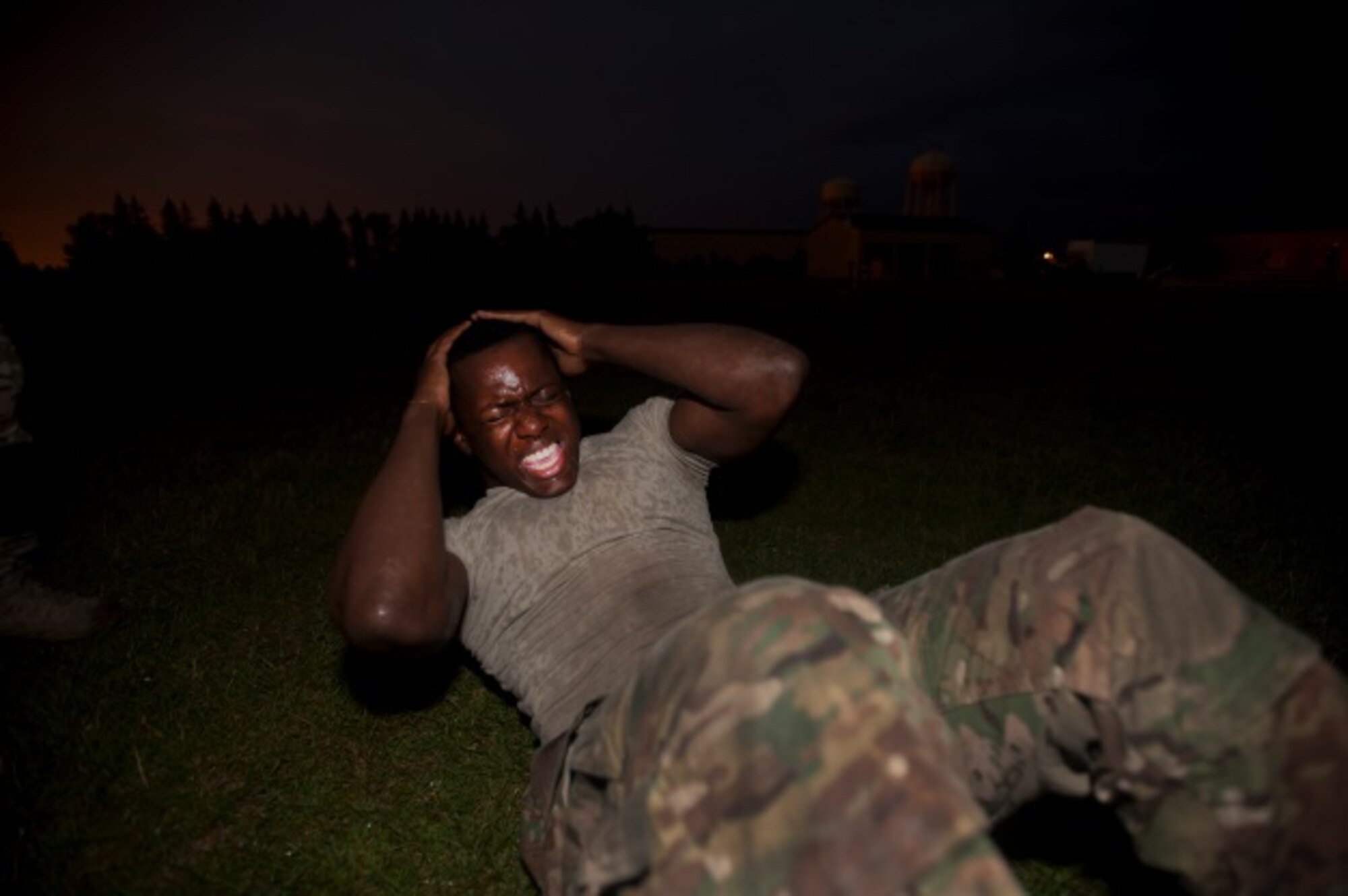 Airman 1st Class Anthony Styles, 5th Security Forces Squadron ranger assessment course trainee, finishes the sit-up portion of the Ranger Physical Assessment at Minot Air Force Base, N.D., July 15, 2015. To qualify to be a ranger, Styles is required to complete a minimum of 49 push ups, 59 sit ups, and six chin ups along with a five-mile run in 40 minutes or less. (U.S. Air Force photo/Airman 1st Class Christian Sullivan)