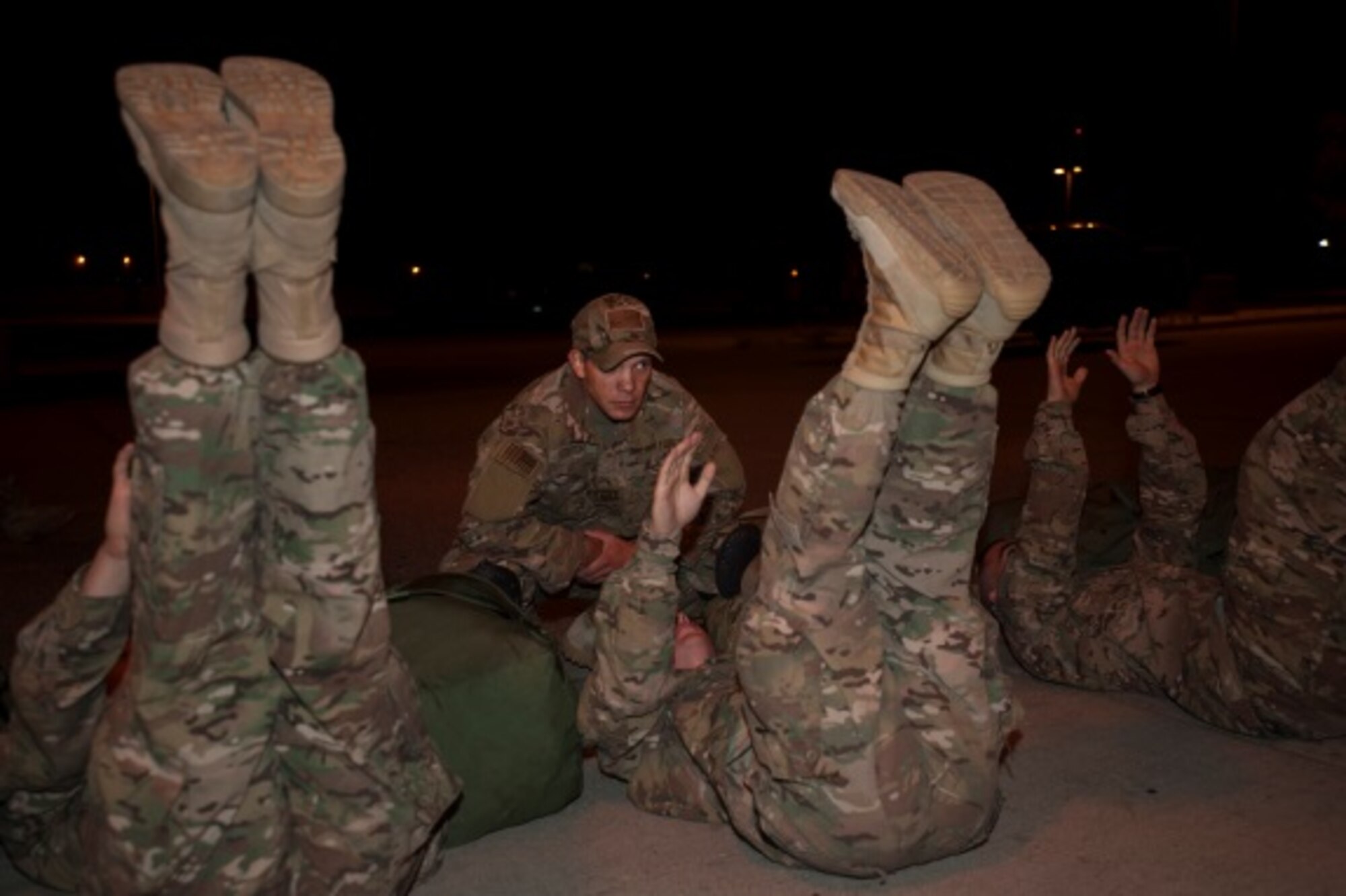 Tech. Sgt. Robert Leighton, 5th Security Forces Squadron ranger assessment course cadre member, motivates Airmen during a ranger assessment course at Minot Air Force Base, N.D., July 15, 2015. The course is stress oriented and is designed to develop the ability to lead and command under heavy mental, emotional and physical strain, while at the same time improving an Airman’s resiliency and coping mechanisms to battle duty-related stress, said Master Sgt. Todd Boren, 5SFS cadre member. (U.S. Air Force photo/Airman 1st Class Christian Sullivan)