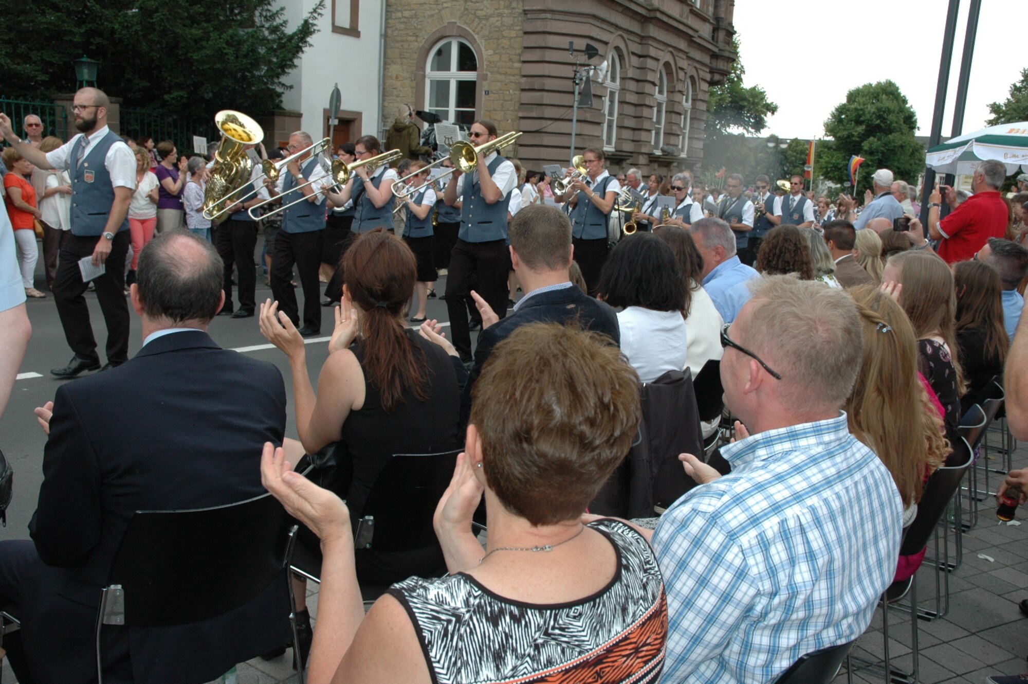 German and American spectators watch the City of Bitburg's Folklore festival in Bitburg, Germany, July 12, 2015. Observers participated in the events in commemoration of the city's 1,300th anniversary and the Folk Festival's 50th anniversary. (U.S. Air Force photo by Iris Reiff/Released)