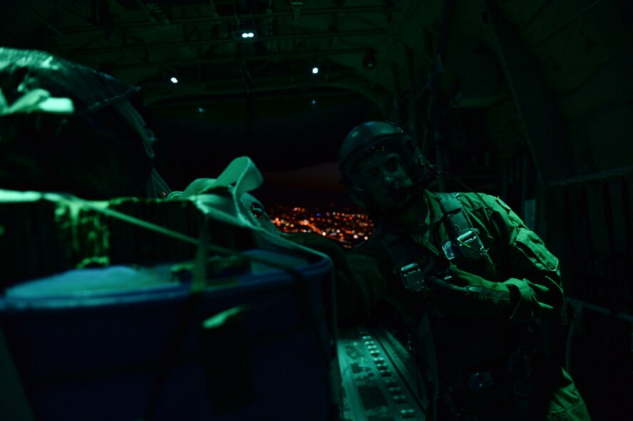 U.S. Air Force Staff Sgt. James Letts 37th Airlift Squadron loadmaster, guides cargo off of a C-130J Super Hercules over Plovdiv, Bulgaria, July 15, 2015. Three C-130Js dropped four containers of water during the cargo drop training flight. This cargo drop was one of more than 25 during a two-week-long deployment to Plovdiv. The U.S. Air Force’s forward presence in Europe allows us to work with our allies and partners to develop and improve ready air forces capable of maintaining regional security. (U.S. Air Force photo/Senior Airman Nicole Sikorski)
