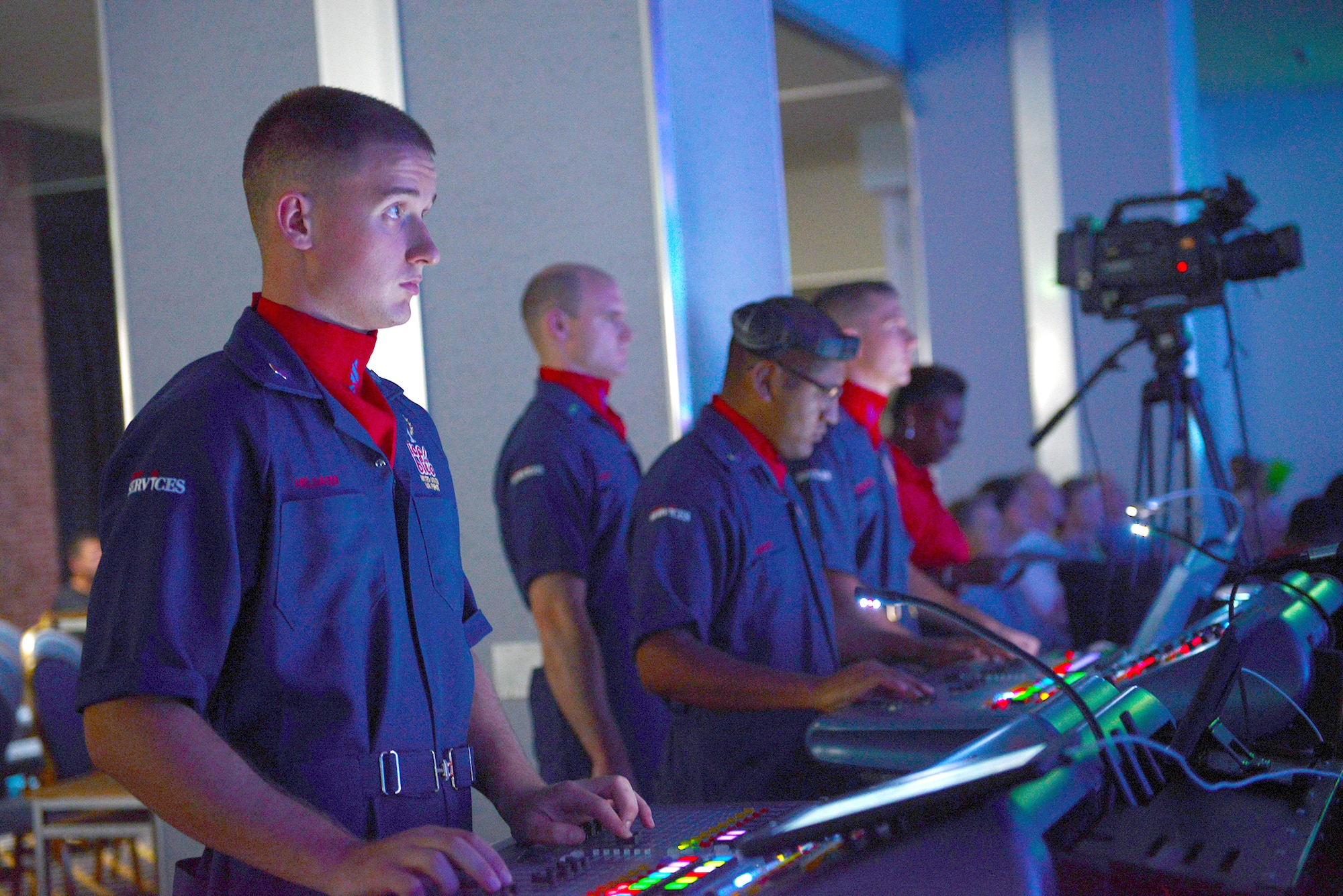 Airmen with the Tops in Blue coordinate stage lighting during a show at Yokota Air Base, Japan, July 19, 2015. Tops in Blue, an Air Force performance ensemble, is a self-contained expeditionary entertainment unit consisting of four flights; personnel, logistics, operations and technical. (U.S. Air Force photo by Airman 1st Class David C. Danford/Released)