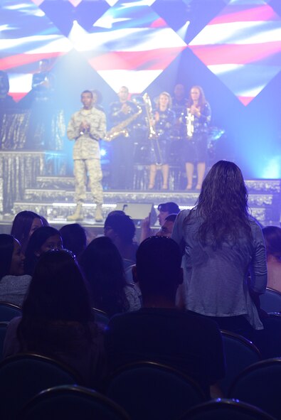 Staff Sgt. Brittany Masters, 374th Contracting Squadron contract specialist, is acknowledged for her contributions to Yokota Air Base and the local community during a Tops in Blue performance at Yokota AB, Japan, July 19, 2015. Tops in Blue provides entertainment to Air Force personnel stationed worldwide, including remote and deployed locations. (U.S. Air Force photo by Airman 1st Class David C. Danford/Released)