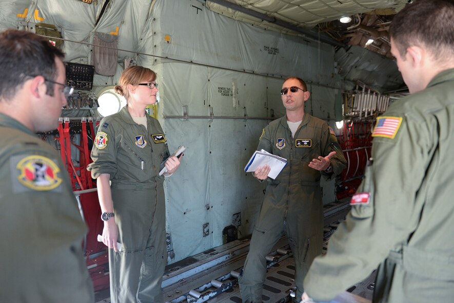 A C-130 Hercules air crew from the 36th Airlift Squadron conducts a mission briefing at Yokota Air Base, Japan, July 14, 2015. The mission tested Yokota’s ability to fly a maximum number of aircraft at once and exercised large scale force employment. (U.S. Air Force photos by Airman 1st Class Elizabeth Baker/Released)