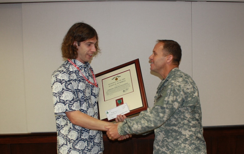 Mr. Justin Pummell (l) is presented a “Commanders Award for Civilian Service” from Brigadier General Jeff Milhorn for his efforts in support of USACE recovery operations following the 24 April 2015 earthquake in Nepal.
