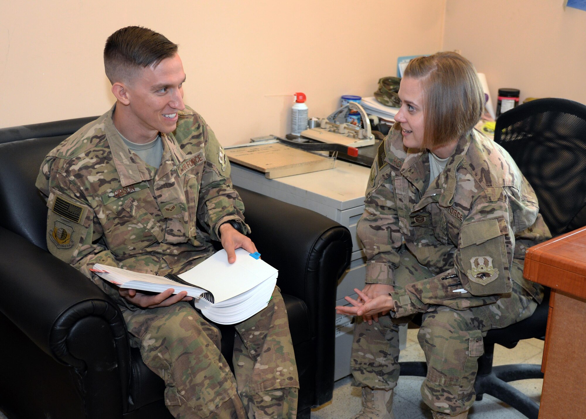 U.S. Air Force Master Sgt. Natasha Hoglund, 455th Air Expeditionary Wing Legal Office superintendent, gives legal advice to Senior Airman Cory Gibson, 455th AEW Finance Office customer service technician, July 18, 2015, at Bagram Airfield, Afghanistan. The legal office is here to help military members with legal issues they may be dealing with at home and here in the AOR. (U.S. Air Force photo by Senior Airman Cierra Presentado/Released)