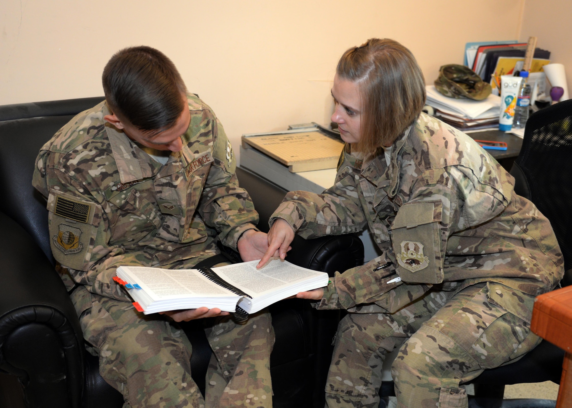 U.S. Air Force Master Sgt. Natasha Hoglund, 455th Air Expeditionary Wing Legal Office superintendent, helps Senior Airman Cory Gibson, 455th AEW Finance Office customer service technician with legal assistance July 18, 2015, at Bagram Airfield, Afghanistan. The legal office is here to help military members with legal issues they may be dealing with at home and here in the AOR. (U.S. Air Force photo by Senior Airman Cierra Presentado/Released)