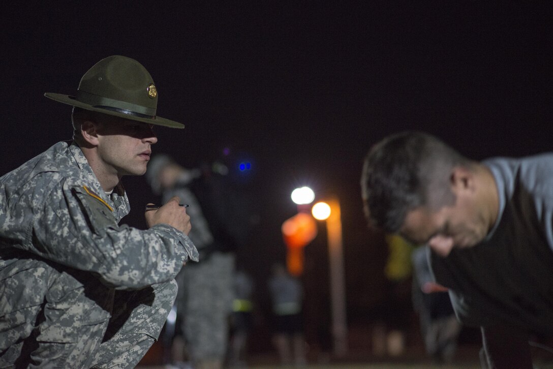A drill sergeant assigned to the 95th Training Division counts push-ups for a competitor at the 2015 U.S. Army Reserve Best Warrior Competition at Fort Bragg, N.C., May 5, 2015. This year’s Best Warrior competition will determine the top noncommissioned officer and junior enlisted Soldier who will represent the Army Reserve in the Department of the Army Best Warrior competition later this year at Fort Lee, Va. (U.S. Army photo by Sgt. 1st Class Mark Burrell, JPASE)
