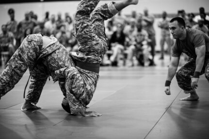 Staff Sgt. Victor Ramos flips over Sgt. Julio Lopez Cintrone during the Modern Army Combatives tournament at the 2014 U.S. Army Reserve Best Warrior Competition, June 26, at Joint Base McGuire-Dix-Lakehurst, N.J. The tournament concluded the four-day Best Warrior competition. (U.S. Army photo by Timothy L. Hale/Released)