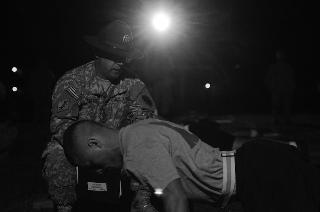 Staff Sgt. James Smith, drill sergeant assigned to the 95th Training Division, 2nd Battalion, 397th Regiment, grades the push-up event at the 2015 U.S. Army Reserve Best Warrior Competition at Fort Bragg, N.C., May 5. This year's Best Warrior competition will determine the top noncommissioned officer and junior enlisted Soldier who will represent the Army Reserve in the Department of the Army Best Warrior competition later this year at Fort Lee, Va. (U.S. Army Reserve photo by Brian Godette/released)