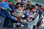 Dale Earnhardt Jr., driver of the No. 88 National Guard NASCAR racecar, stops to sign autographs for fans at Pocono Raceway June 12, 2011 in Long Pond, Pa. Dale Jr. is now only ten points behind the leader in the Sprint Cup series points race after finishing in sixth place Sunday.