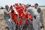 UH-60 Black Hawk crewmembers from the  Florida Army National Guard's 1st Battalion, 244th Aviation Regiment, prepare a collapsible water bucket to support wildfire suppression missions in northeast Florida, June 16, 2011. Each bucket can hold 780 gallons of water and be carried under the Army helicopters. The aviators were helping the Florida Division of Forestry and firefighters by dropping water on spreading wildfires sparked by lightning.