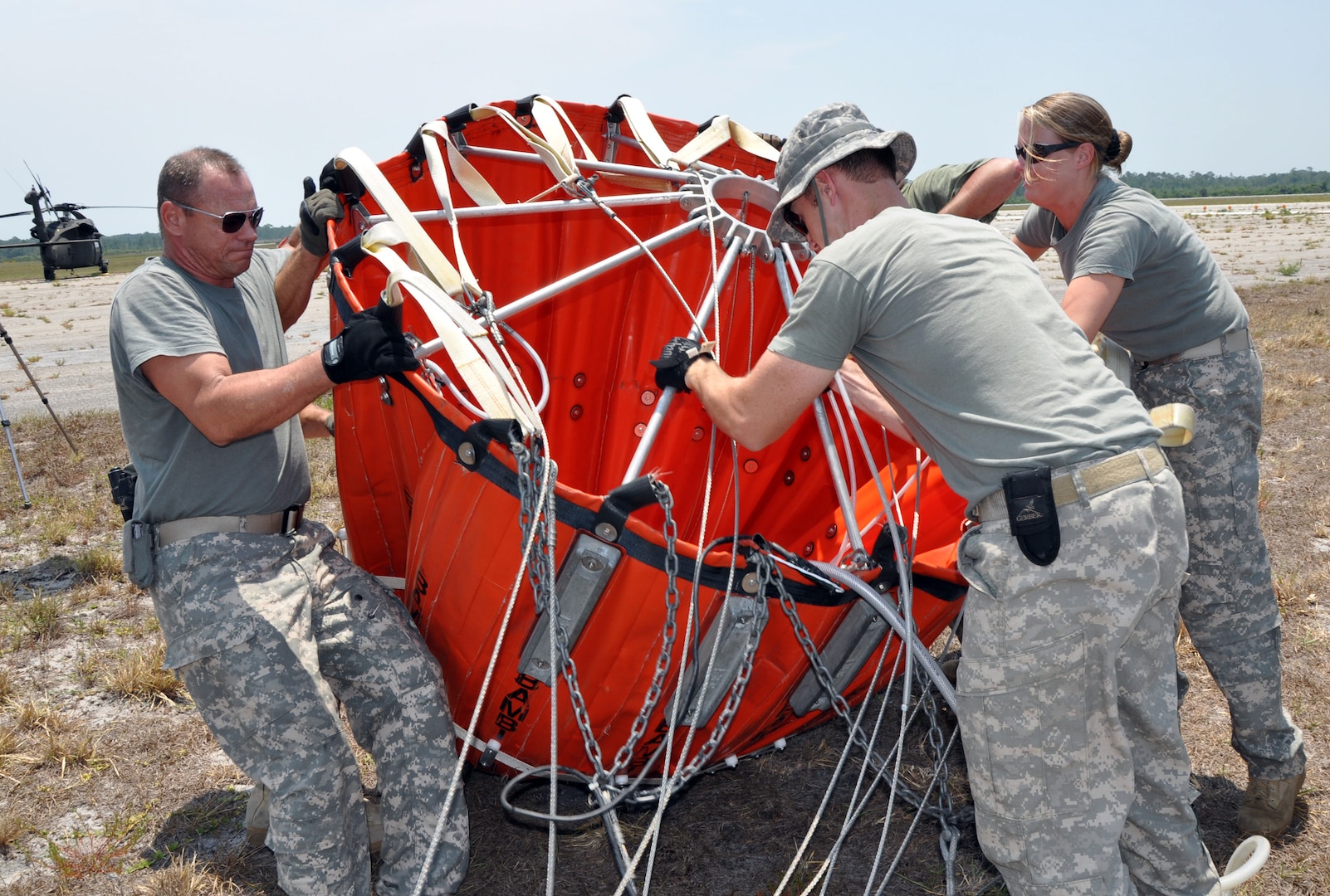UH-60 Black Hawk crewmembers from the  Florida Army National Guard's 1st Battalion, 244th Aviation Regiment, prepare a collapsible water bucket to support wildfire suppression missions in northeast Florida, June 16, 2011. Each bucket can hold 780 gallons of water and be carried under the Army helicopters. The aviators were helping the Florida Division of Forestry and firefighters by dropping water on spreading wildfires sparked by lightning.