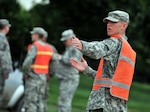 Army Pfc. Thad Buri, Watertown, a service member of the 235th Military Police Company, directs traffic at a traffic control point in Dakota Dunes, June 17, 2011. Buri and other members of the 235th Military Police Company are conducting traffic control and ID checks as local residents return to survey potential damages to their homes caused by the flooding of the Missouri River.