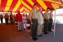 Marines and Sailors both active and retired with 2nd Battalion, 4th Marines, 1st Marine Division stood at attention as the song Waltzing Matilda played during a 2/4 Association award ceremony aboard Marine Corps Base Camp Pendleton, California, July 17, 2015. Waltzing Matilda was played to commemorate those who had served with 2/4 in World War II.