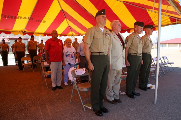 Marines and Sailors both active and retired with 2nd Battalion, 4th Marines, 1st Marine Division stood at attention as the song Waltzing Matilda played during a 2/4 Association award ceremony aboard Marine Corps Base Camp Pendleton, California, July 17, 2015. Waltzing Matilda was played to commemorate those who had served with 2/4 in World War II.
