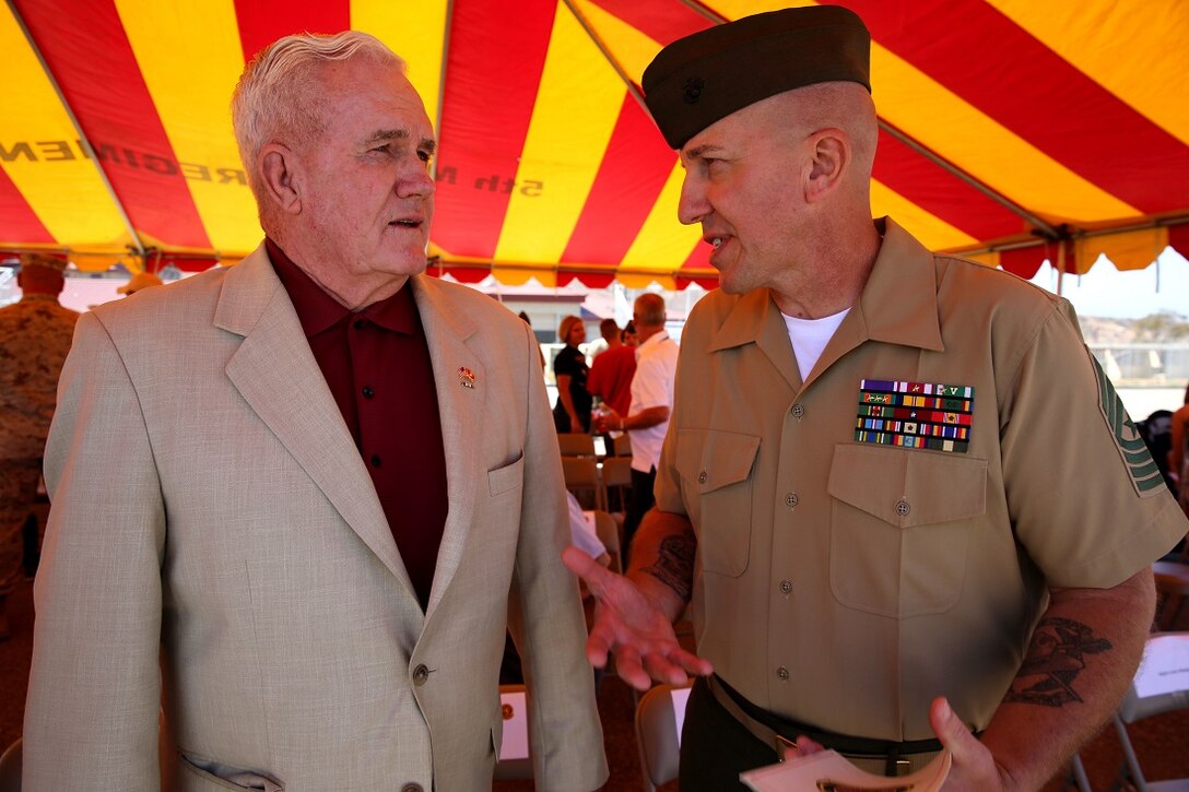 Sgt. Maj. Mike Bolyard, the sergeant major of 2nd Battalion, 4th Marines, 1st Marine Division, speaks to Col. Jim Williams (Ret.), the 2/4 Association liaison, after an award ceremony aboard Marine Corps Base Camp Pendleton, California, July 17, 2015. The 2/4 Association is an organization, which supports active duty, retired and honorably discharged Marines and Sailors and have served with 2/4 through the years.