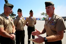 Col. Ken Kassner, the commanding officer of 5th Marine Regiment, 1st Marine Division, speaks to some of the award recipients after a 2nd Battalion, 4th Marines Association award ceremony aboard Marine Corps Base Camp Pendleton, California, July 17, 2015. After the ceremony, Kassner personally congratulated the award recipients and spoke to them about the importance of leadership.