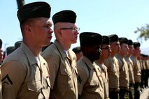 Marines with 2nd Battalion, 4th Marines, 1st Marine Division, stand at parade rest, while the commanding officer gives his remarks during a 2/4 Association award ceremony aboard Marine Corps Base Camp Pendleton, California, July 17, 2015. During the ceremony, Marines stood in formation as the designated Marines and Sailor received their awards from the commanding officer of 2/4 and the 2/4 Association liaison.