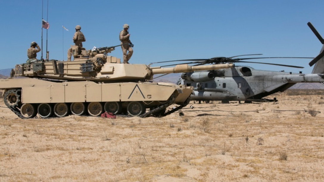 Marines of Company A, 1st Tank Battalion, prepare an M1A1 Abrams tank to receive fuel from a CH-53 Super Stallion with Marine Heavy Helicopter Squadron 465 at Acorn Training Area, July 16, 2015. Each tank has the capability to hold 500 gallons of fuel. 
