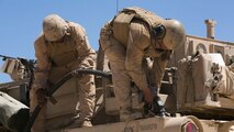 Staff Sgt. David Babers, tank commander, and Lance Cpl. Alejandro Cruzzuriga, loader, Company A, 1st Tanks Battalion, refuel an M1A1 Abrams Tank at Acorn Training Area, July 16, 2015. Each tank has two fuel tanks that hold approximately 250 gallons of fuel. 