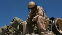 Sgt. Justin Cope, tank commander, Company A, 1st Tank Battalion, examines an M1A1 Abrams Tank’s rear fuel tank at Acorn Training Area, July 16, 2015. Each company within 1st Tanks consists of approximately 14 tanks. 