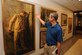 Retired Col. Leon Ellis visits the Air Force prisoner of war tribute section in the Pentagon July 16, 2015. Ellis, a Vietnam War POW, admired a painting by Maxine McCaffrey. The painting portrays realistic features about being a captive in a prison camp. (U.S. Air Force photo/Staff Sgt. Whitney Stanfield)