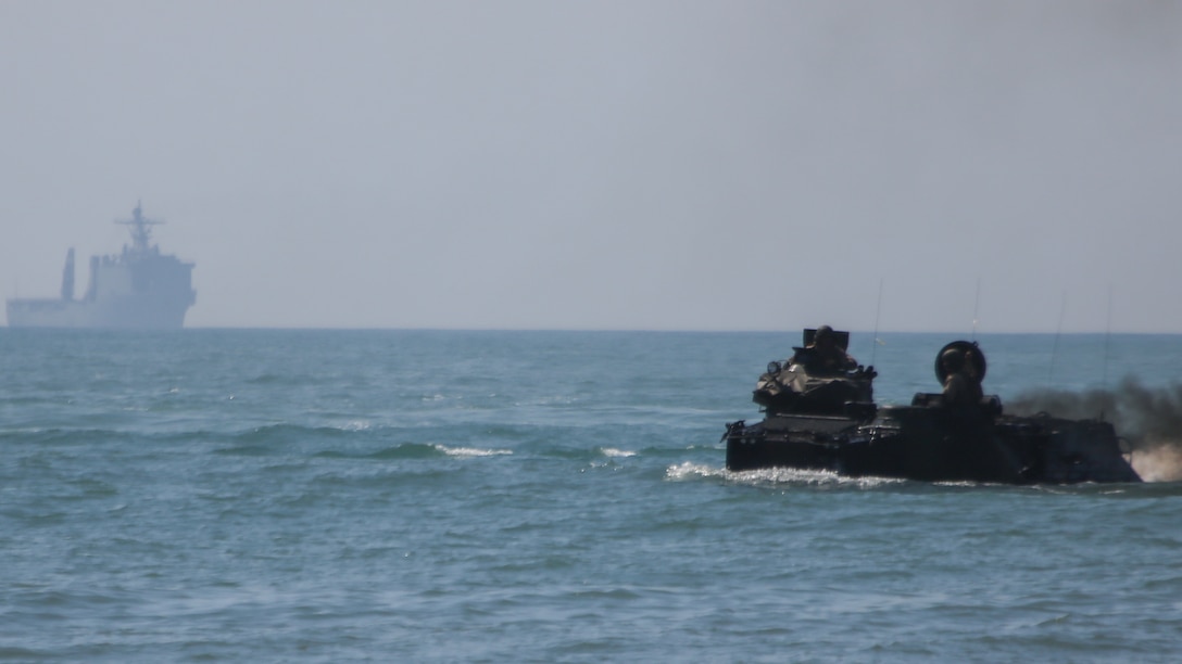 Marines with 2nd Assault Amphibious Battalion, 2nd Marine Division, drive assault amphibious vehicles to shore from the USS Whidbey Island during amphibious training operations in the waters off the coast of Marine Corps Base Camp Lejeune, North Carolina, July 16, 2015. The exercise allowed Marines to fulfill their required ship operations and gave sailors aboard the Whidbey Island the opportunity to work with Marines during their own amphibious training.