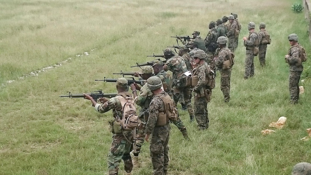 U.S. Marines with Special-Purpose Marine Air-Ground Task Force Crisis Response-Africa, observe a relay of Ghanaian Soldiers completing marksmanship training near Accra, Ghana, June 30, 2015. The Marines and Sailors of SPMAGTF-CR-AF partnered with the Ghana Army for a month-long exercise  focused on infantry skills while strengthening the relationship and interoperability between the two forces. 