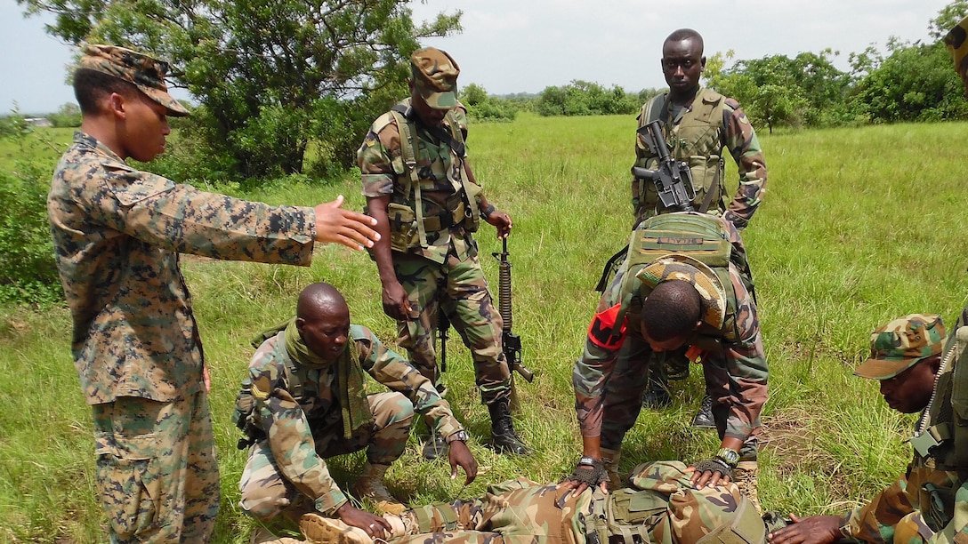 U.S. Marine Cpl. Stephan James, a team leader with Special-Purpose Marine Air-Ground Task Force Crisis Response-Africa, directs Ghanaian soldiers moving a simulated casualty to a litter near Accra, Ghana, June 23, 2015. The Marines and Sailors of SPMAGTF-CR-AF partnered with the Ghanaian army for a month-long security cooperation exercise in infantry skills to help foster a stronger working relationship between the two nations’ militaries. 