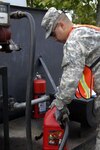 Army Spc. Eric Sierra, a Puerto Rican National Guard Soldier assigned to the 191st Readiness Support Company, pumps fuel into a gas can for vehicles in support of the Fuerzas Comando 2011 competition June 13, 2011. Fuerzas Comando, established in 2004, is a U.S. Southern Command-sponsored special operations skills competition and senior leader seminar which is conducted annually in Central and South America and the Caribbean and is scheduled to run June 15-23.