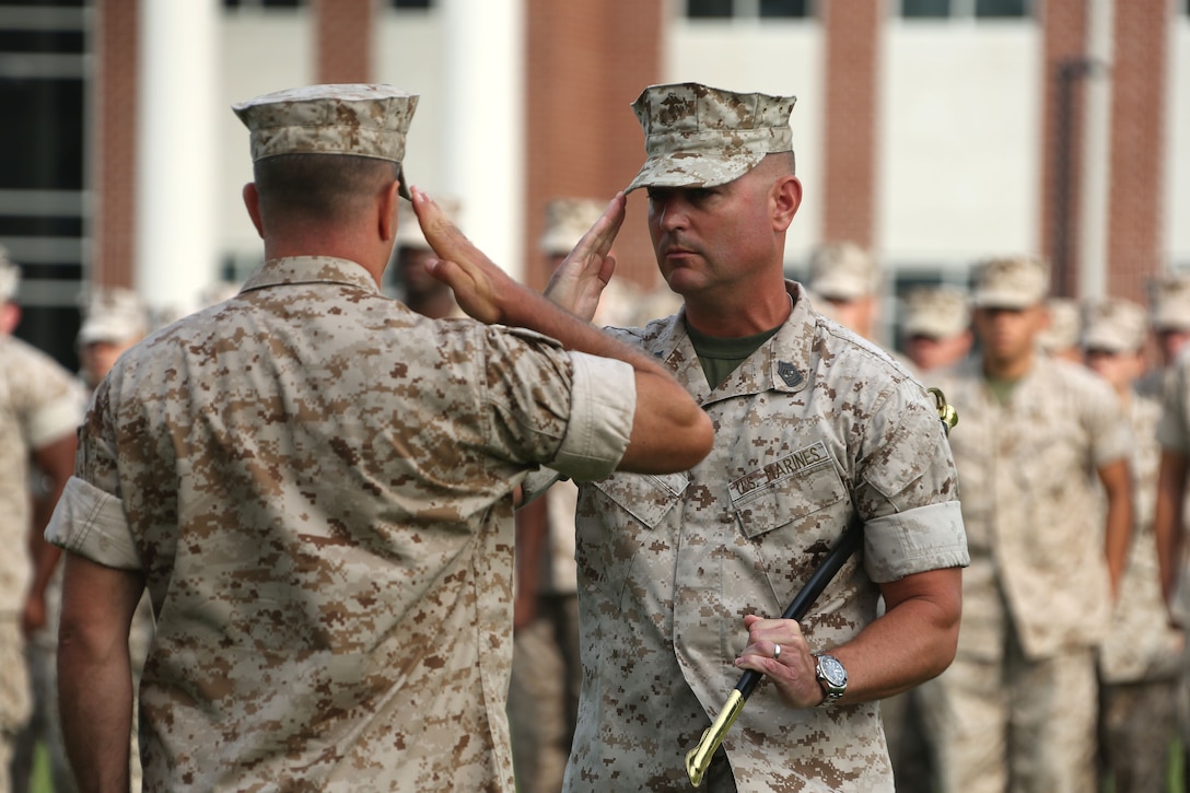 Lt. Col. William R. DeLorenzo,left, commanding officer, Marine Wing Headquarters Squadron 2, presents the sword of office to Sgt. Maj. James D. Vealey during a ceremony at Marine Corps Air Station Cherry Point, N.C., July 21, 2015. Vealey was appointed to MWHS-2 as the new squadron sergeant major. (U.S Marine Corps photo by Cpl. N.W. Huertas/ Released)    