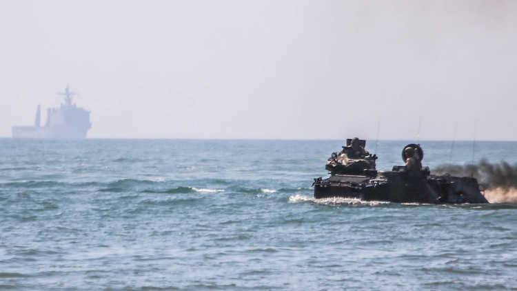 Marines with 2nd Assault Amphibious Battalion, 2nd Marine Division, drive assault amphibious vehicles to shore from the USS Whidbey Island during amphibious training operations in the waters off the coast of Camp Lejeune, N.C., July 16, 2015. The exercise allowed Marines to fulfill their required ship operations and gave sailors aboard the Whidbey Island the opportunity to work with Marines during their own amphibious training.