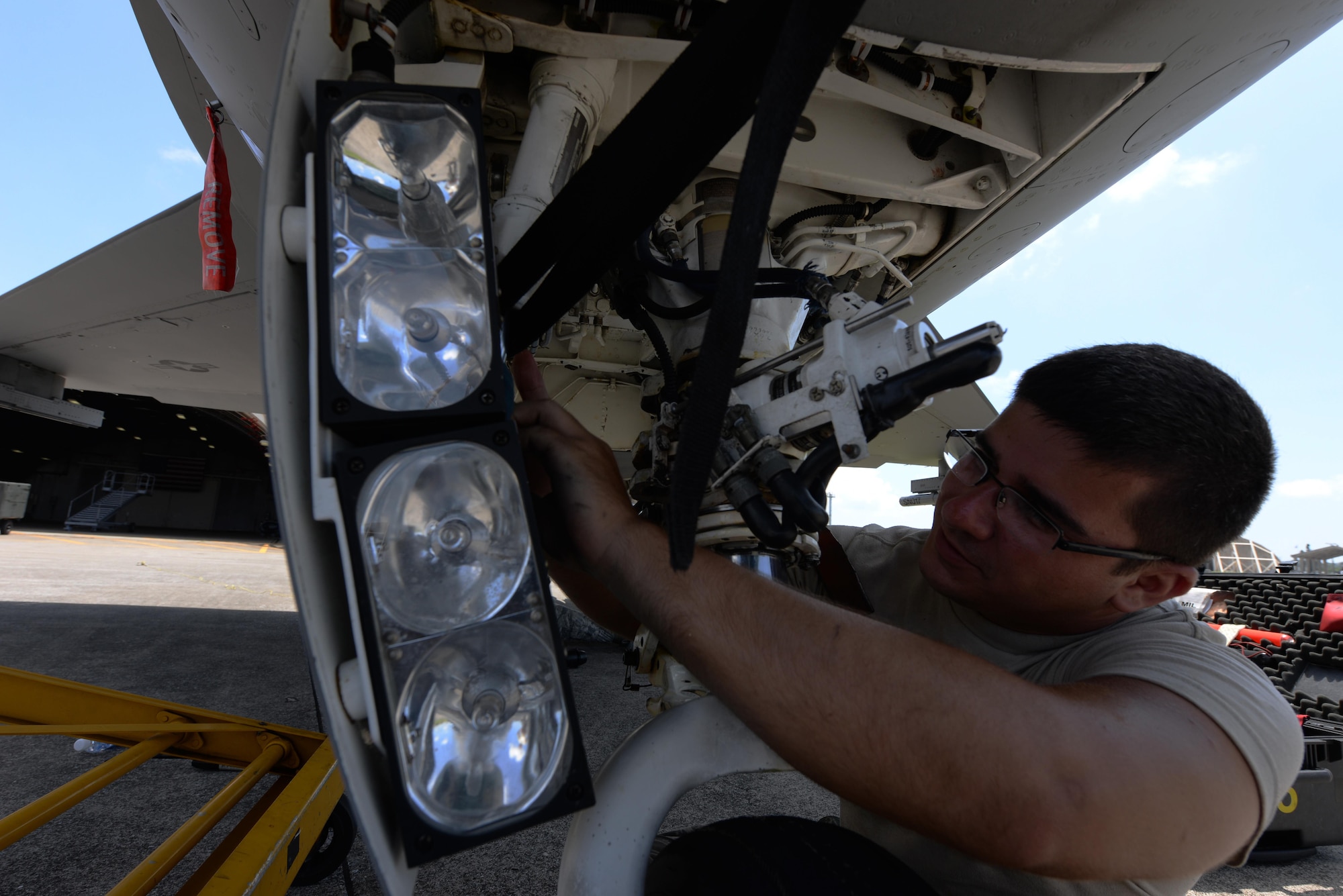 U.S. Air Force Senior Airman Derek Hoague, 158th Fighter Wing F-16 Fighting Falcon crew chief, wipes down the landing gear of an F-16 to prevent corrosion on Kadena Air Base, Japan, July 16, 2015. The 158th Fighter Wing of Vermont is currently deployed to Kadena as part of a Pacific Command Theater Security Package to enhance regional security in the Indo-Asia-Pacific region and demonstrate the U.S. commitment to stability in the region. (U.S. Air Force photo by Senior Airman Omari Bernard/Released)