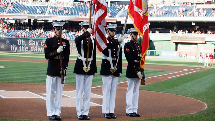 A Marine color guard presents the colors during the playing of the National Anthem, July 21, 2015, at Nationals Park in Washington. The Washington Nationals hosted a Marine Corps Day to honor Marines who serve and who have served in the past. 