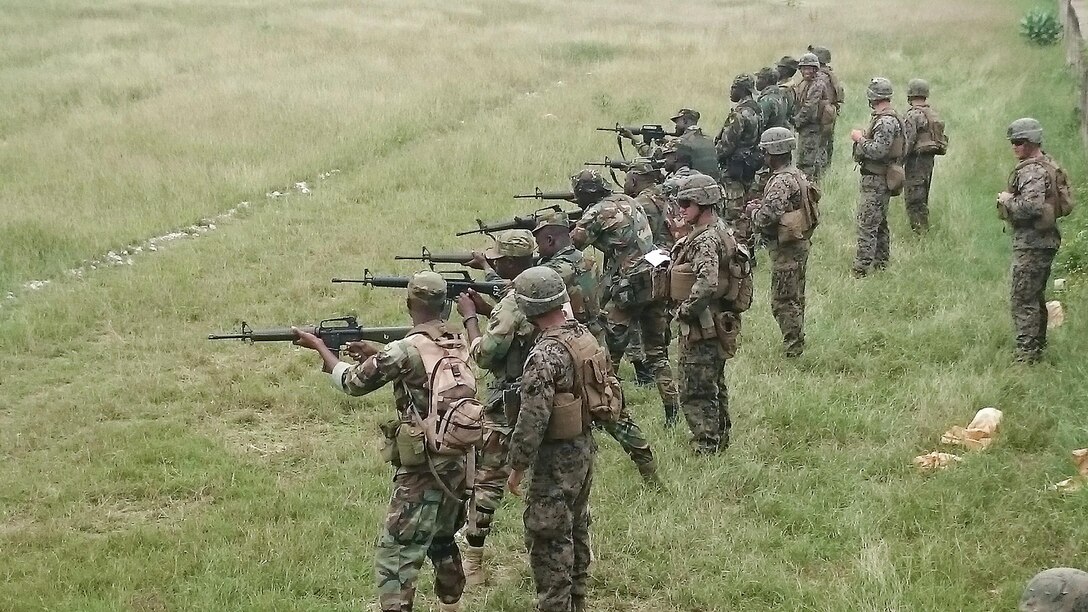 U.S. Marines with Special-Purpose Marine Air-Ground Task Force Crisis Response-Africa, observe a relay of Ghanaian Soldiers completing marksmanship training near Accra, Ghana, June 30, 2015. The Marines and Sailors of SPMAGTF-CR-AF partnered with the Ghana Army for a month-long exercise  focused on infantry skills while strengthening the relationship and interoperability between the two forces. 