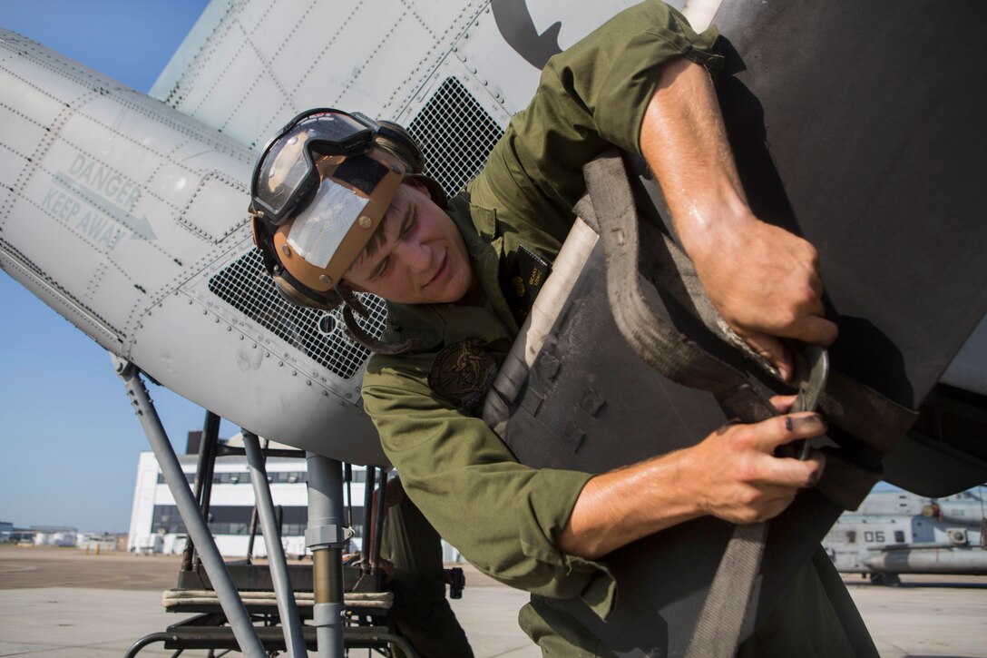 Marine Corps Pfc. Tyler R. Geary ties down a propeller during a routine maintenance check on a CH-53E Super Stallion helicopter on Marine Corps Air Station Cherry Point, N.C., July 10, 2015. Geary is a flight line mechanic assigned to Marine Heavy Helicopter Squadron 366.
