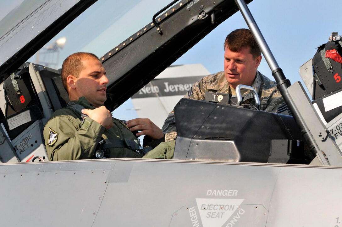 U.S. Air Force Chief Master Sgt. Jason Gioconda, right, reviews egress ...