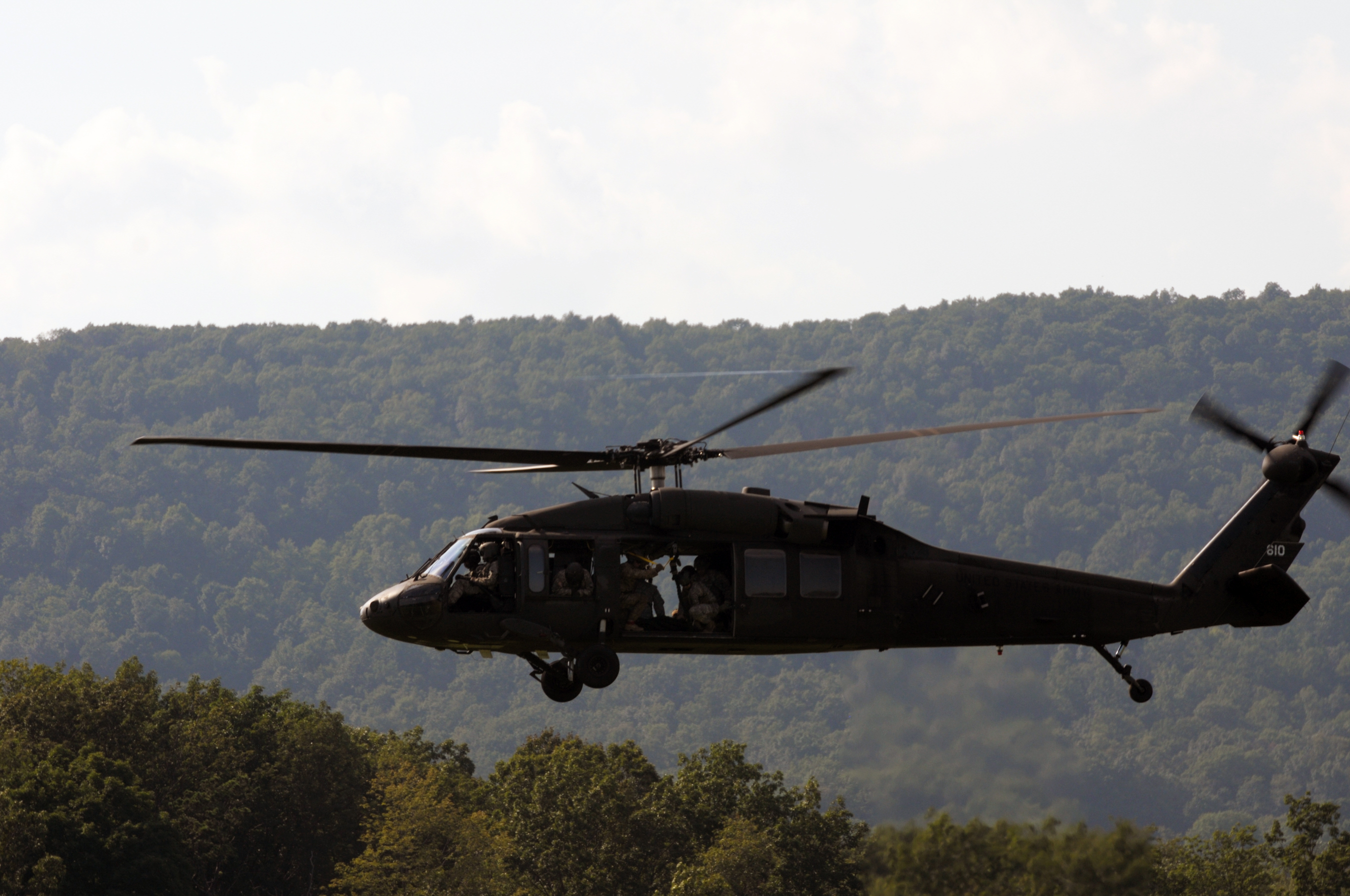 Soldiers on a UH-60 Black Hawk prepare for a fast-rope insertion ...