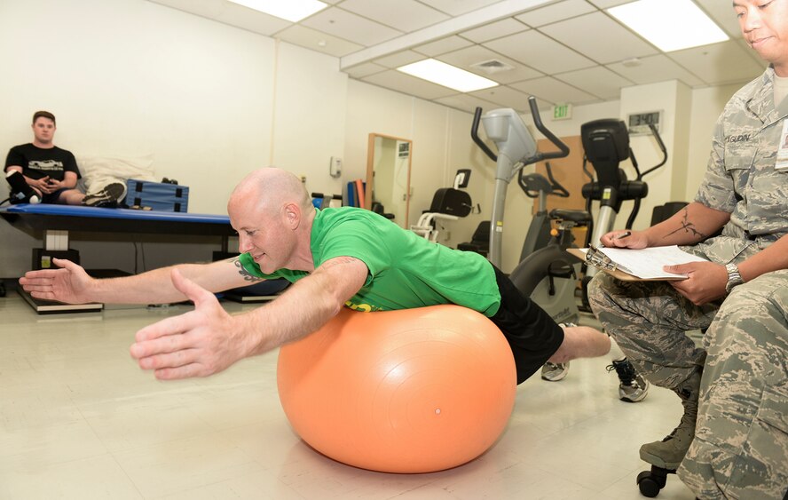 Master Sgt. John David Phillips, 374th Maintenance Squadron fabrication flight chief, exercises as part of his physical therapy routine at Yokota Air Base, Japan, June 6, 2015.  Recovery is often a slow and steady process which requires both mental and physical effort from the patient, but through discipline and determination, Airmen often return to fitness. (U.S. Air Force photo by Airman 1st Class Elizabeth Baker/Released)
