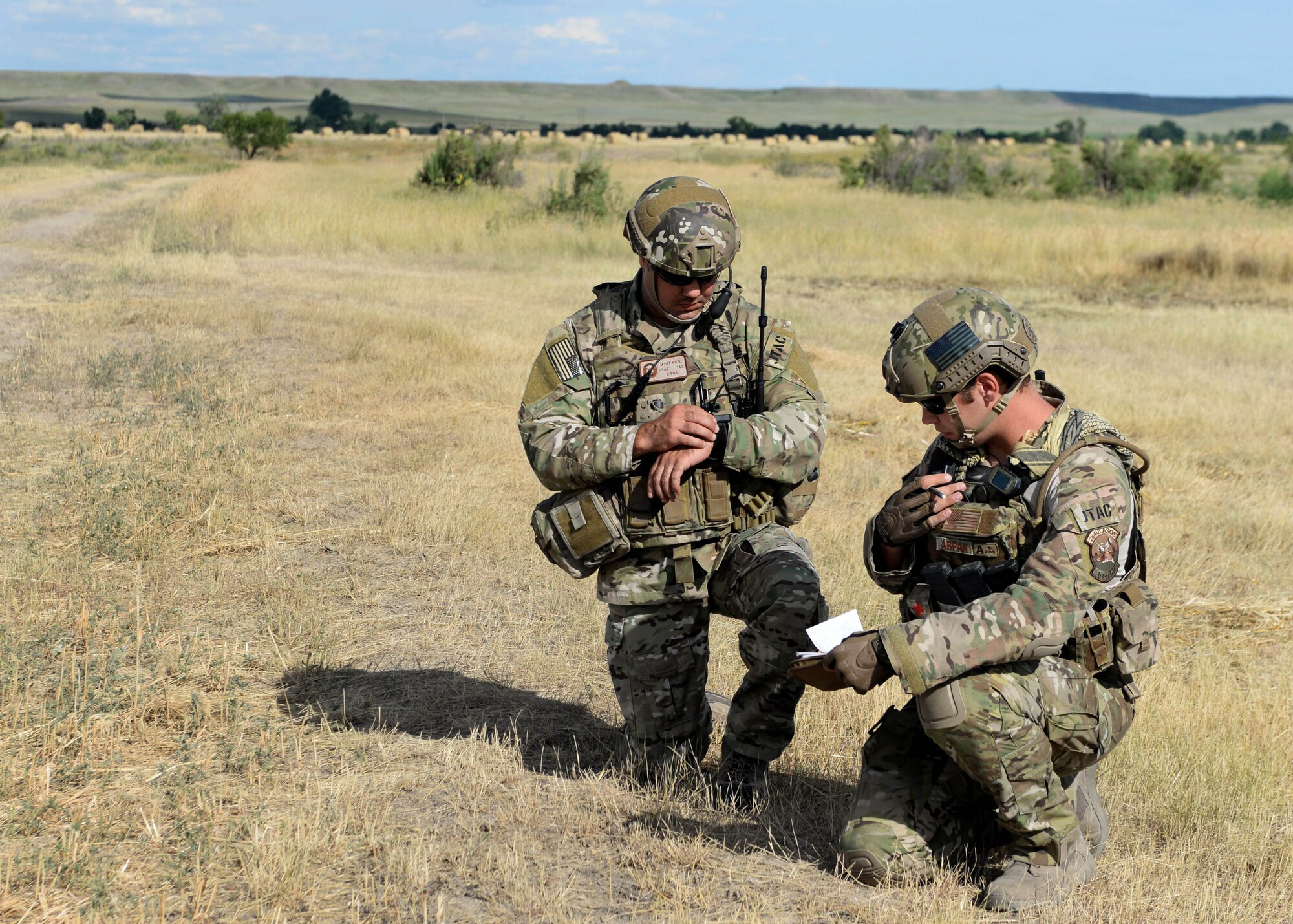 Kansas Air National Guard Master Sgt. Jeffrey Rick, 284th Air Support Operations Squadron operations superintendent (left), and KSANG Staff Sgt. Brandon Arpan, 284th ASOS assistant A-flight chief, call in a show of force during a close air support exercise in a training area near Alzada, Mont., July 20, 2015. Ellsworth worked with members of the 284th ASOS to provide a demonstration of the close air support missions B-1 bombers execute overseas as a part of Secretary of the Air Force Deborah Lee James’ visit to Ellsworth Air Force Base, S.D. (U.S. Air Force photo by Senior Airman Rebecca Imwalle/Released) 