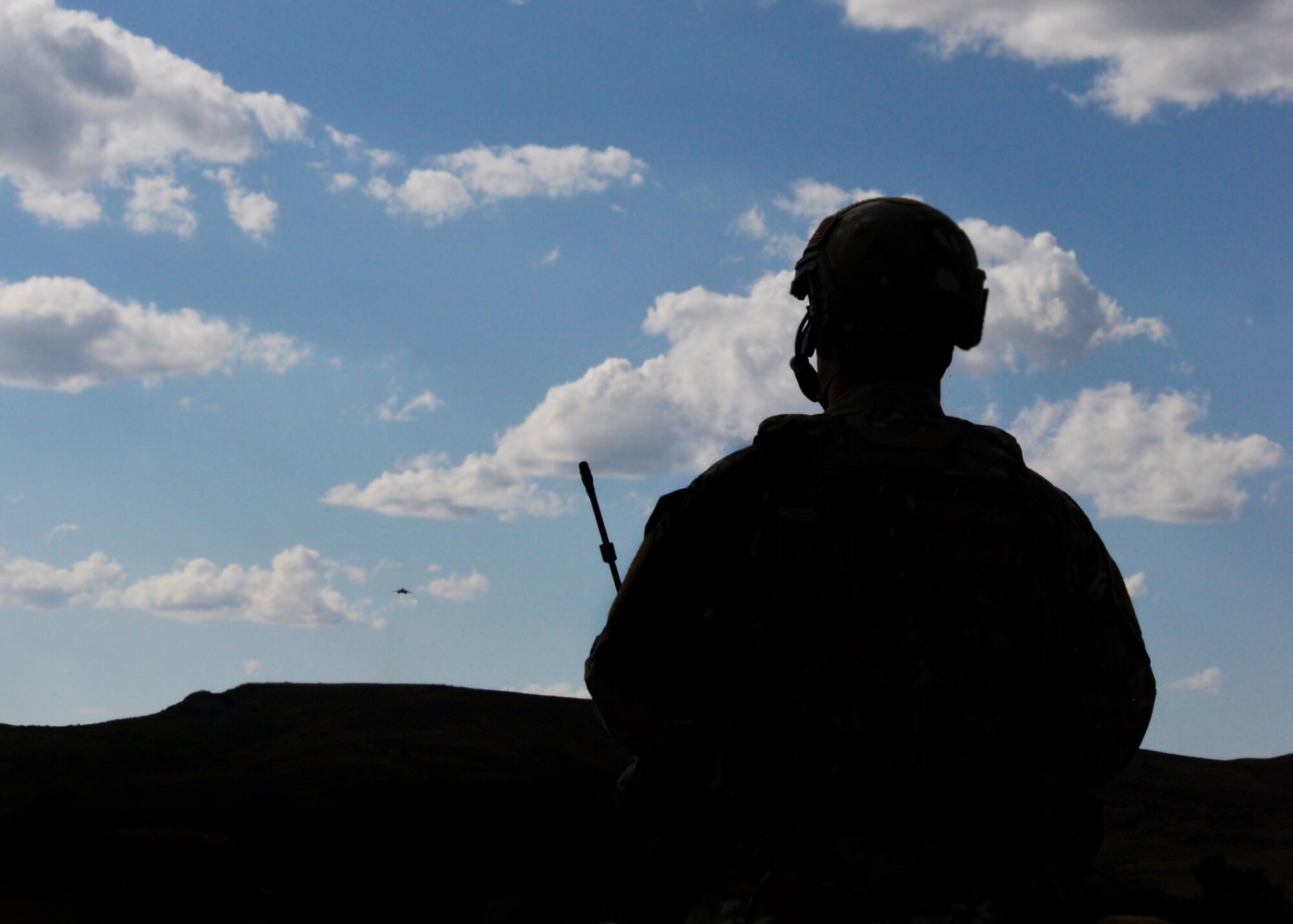 Kansas Air National Guard Staff Sgt. Brandon Arpan, 284th Air Support Operations Squadron assistant A-flight chief, observes the approach of a B-1 bomber during a close air support exercise in a training area near Alzada, Mont., July 20, 2015. During the exercise, part of Secretary of the Air Force Deborah Lee James’ visit to Ellsworth Air Force Base, S.D., Arpan called in a show of force intended to intimidate enemy personnel while simultaneously providing friendly forces an opportunity to withdrawal from dangerous areas. (U.S. Air Force photo by Senior Airman Rebecca Imwalle/Released)